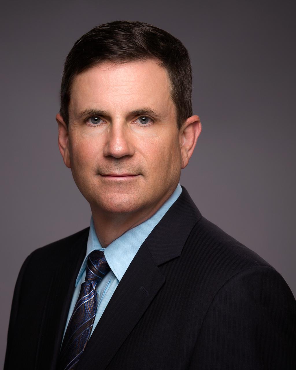 Male professional headshot, suit and tie