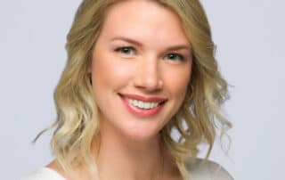 Female Headshot with blonde hair and a big smile